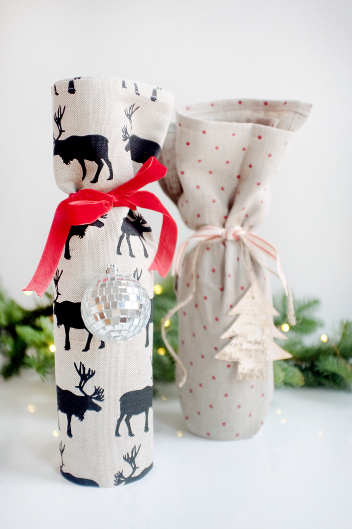 Botella de vino con embalaje de tela, regalo de Navidad, renos y árbol de Navidad, regalar vino