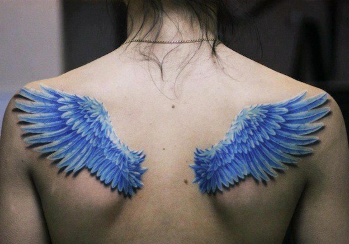 一个女人有两个蓝色的天使翅膀，长着蓝色的长羽毛 - 另一个天使翅膀纹身的想法