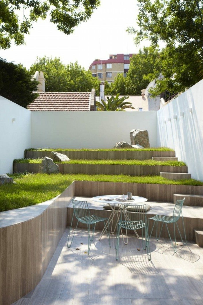 un jardín con césped, muebles de jardín simples - ejemplos de jardinería