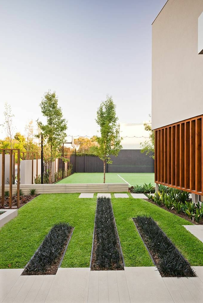 moderno patio delantero con césped bien cuidado y algunos árboles tan geométricos