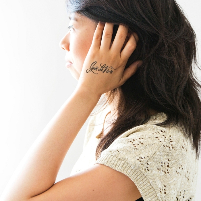 tetovaža motiva suptilna ideja za žene pišući na ruci crna kose čipke pletene bluze